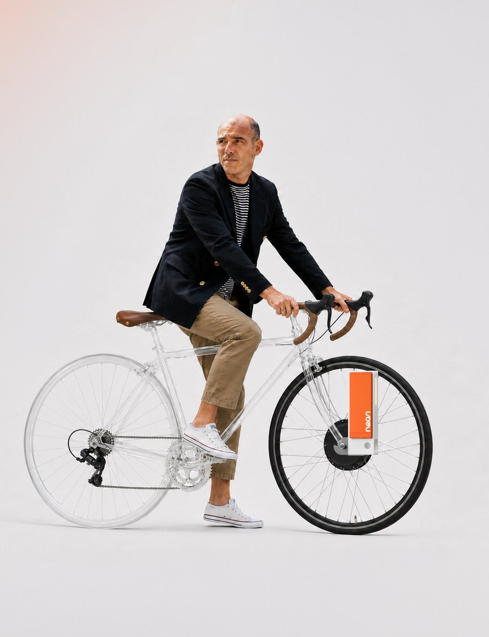 A rider on a road bike fitted with the neon front wheel and its orange core