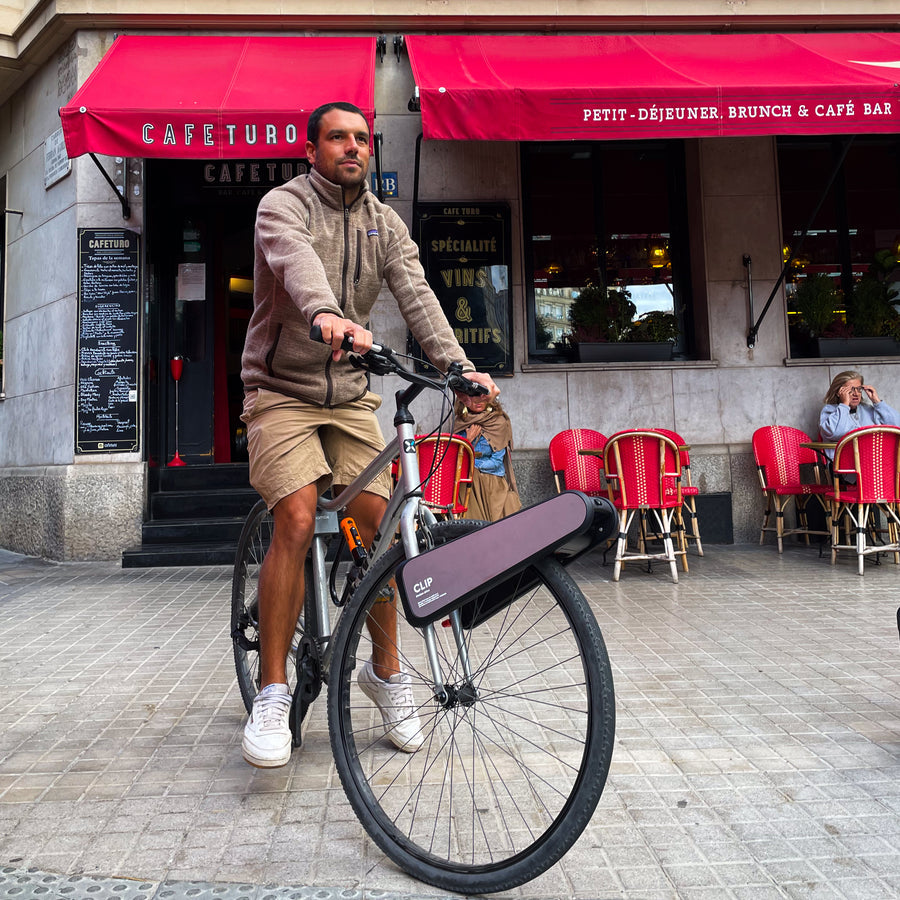 Rider on a CLIP bike outside a Paris café