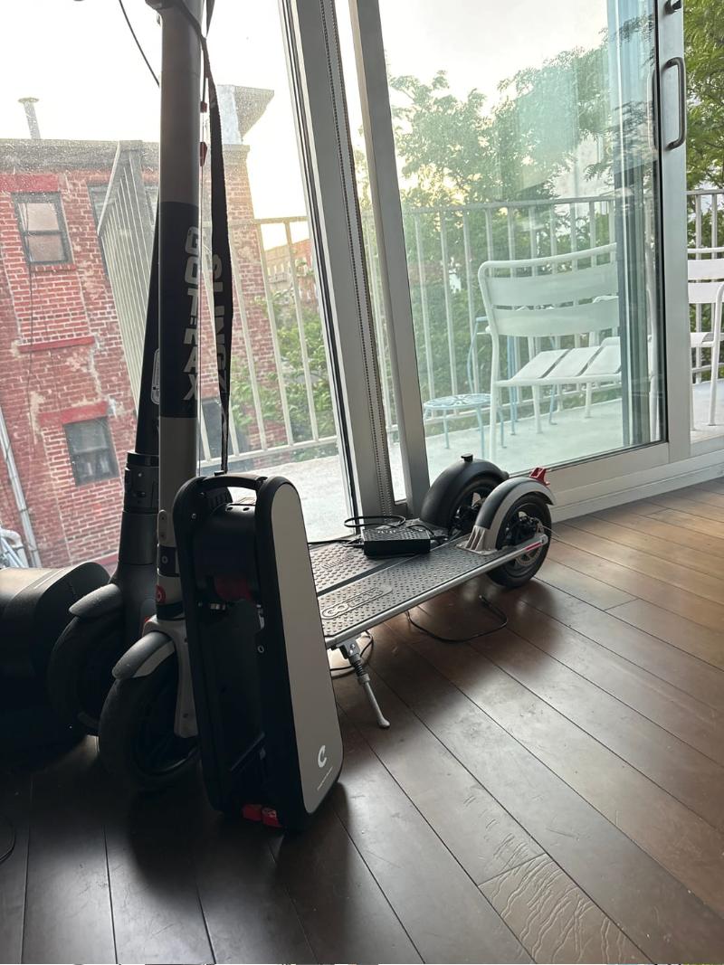 Sonia's CLIP standing by her balcony door at home in Brooklyn