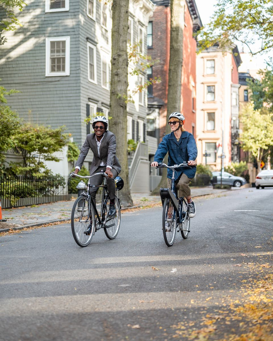 Two riders with CLIP on a tree-lined Brooklyn street